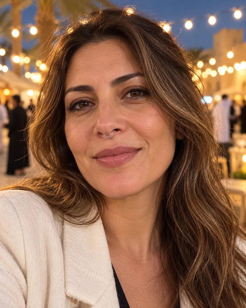 A woman at an outdoor evening event wearing NASMA